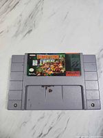 Front of Donkey Kong Country SNES cartridge showing label and shell wear