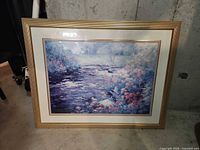 Full view of framed landscape print leaning against wall