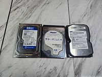 Front view of three 3.5-inch HDDs showing labels and models