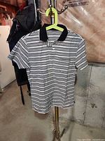Front view of striped polo on hanger