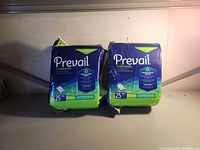 Front view of two sealed Prevail Underpads packages