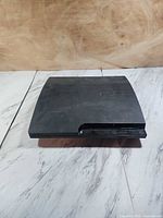 Top and front view of black PS3 slim console