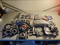 Bulk quantity of packaged silicone phone holders spread on table