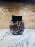 Front view of art glass vase showing swirl design and color
