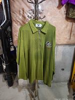 Full view of olive FUBU quarter-zip pullover on hanger