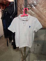 Front view of white U.S. Polo Assn. polo showing placket, collar, chest logo