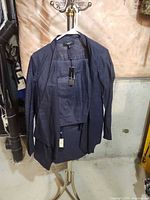 Front view of jacket over shell on stand showing overall style and color