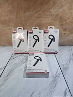 Front view of five XO BE32 headset retail boxes