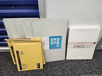 Lot overview showing three magnetic boards, three padded mailers, and 2-pack canvas