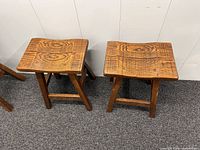 Two of the four wooden bar stools, top view shows plank seats and grain