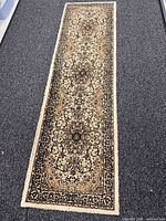 Full view of beige floral runner rug on floor