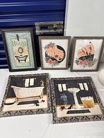 Group shot of five framed artwork pieces