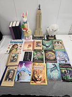 Group shot of all books, LEGO Empire State Building, owl plush and bunny figurine