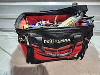 Front view of Craftsman red black tool bag filled with tools