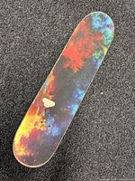 Top of skateboard showing galaxy pattern grip tape