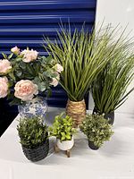 six faux plants displayed together showing size comparison and pot styles