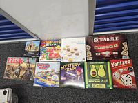 All nine game and puzzle boxes laid out together