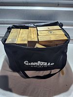 Black nylon Giantville carrying bag filled with wooden blocks