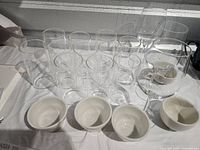 Group view of 11 tumblers, 3 wine glasses and 5 Tuxton teacups