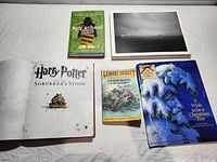 All five books laid out, covers visible