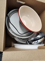 Cardboard box holding dehydrator trays, bowl and kettle