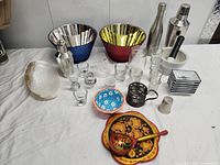 All items laid out including bowls, shakers, glasses, plates, tray, ladle, shell dish, mortar and pestle