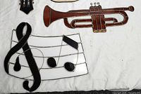 Trumpet, music staff panel with treble clef and notes, partial guitar
