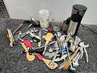 Wide view of coffee grinder and scattered utensils on floor
