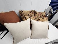Front view of all seven pillows arranged on surface
