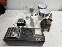 overview of projector, figurines, bowls and drinkware