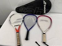 Three rackets and Babolat case on table