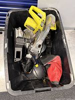 Overview of tote with Ryobi jigsaw, Porter Cable saw, respirator mask, dust bag