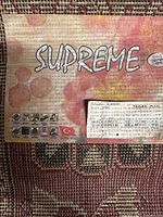 Rug label showing Supreme branding, care icons, Turkish flag, size 200×290 cm