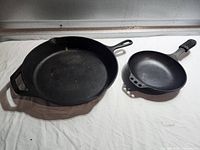 Large Lodge and small Smithey skillets side by side