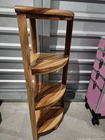 full view of one corner shelf showing three tiers and rounded top rail