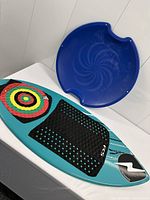 Skimboard and sled together on table