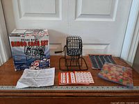 Full set laid out: cage, master board, cards, markers, instructions, box