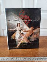 Front cover of the hardcover book with dust jacket and ruler for scale