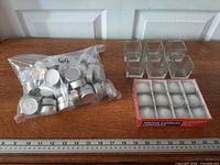 Bag of tealights, box of votive candles, six glass holders on table