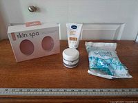 All four sealed personal care items displayed on table
