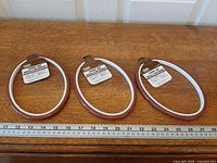 Three Charmin No. 802 oval framing hoops placed side-by-side with ruler for scale