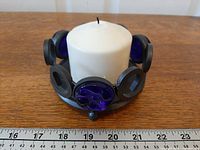 Front view showing candle holder with cobalt blue glass inserts and included ruler for scale