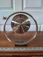 Front view of Daniel Dakota floating lucite clock