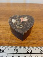 Heart-shaped soapstone trinket box front view next to ruler