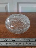 two interlocked bowls forming lidded dish beside ruler