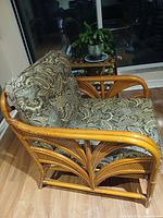 Angled view of bamboo armchair showing frame design and cushions