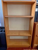 Front view showing full bookcase with two adjustable shelves and base