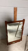 Front view of wood frame mirror with mounting board