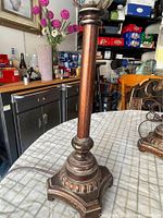 Full view of lamp base and column showing wood-finish column and ornate metal base
