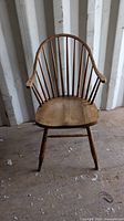 front view of wooden Windsor armchair showing spindle back and seat